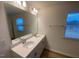 Bathroom featuring a double sink vanity, large mirror, and bright natural light from the window at 544 John Stark Dr, Fuquay Varina, NC 27526