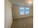 Cozy carpeted bedroom with bright windows, perfect for relaxing and unwinding at 544 John Stark Dr, Fuquay Varina, NC 27526