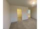 Carpeted bedroom leading to a walk-in closet and adjacent bathroom at 544 John Stark Dr, Fuquay Varina, NC 27526