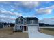 Charming two-story home with gray siding, a well-manicured lawn, and a driveway leading to the garage at 544 John Stark Dr, Fuquay Varina, NC 27526