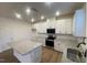 Well-lit kitchen boasts white cabinets, stainless steel appliances, and granite countertops at 544 John Stark Dr, Fuquay Varina, NC 27526