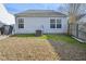 Exterior shot reveals an HVAC unit and grassy area, surrounded by privacy fence and tidy landscaping at 5548 Roan Mountain Pl, Raleigh, NC 27613