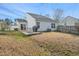 Spacious backyard with a deck, mature trees, and ample space for outdoor activities at 5548 Roan Mountain Pl, Raleigh, NC 27613