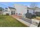 Inviting backyard showcasing a patio with chairs and a grill for outdoor entertaining and relaxation at 5548 Roan Mountain Pl, Raleigh, NC 27613