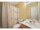 Bathroom featuring floral shower curtain, toilet, sink and mirror at 5548 Roan Mountain Pl, Raleigh, NC 27613