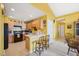 Functional kitchen featuring a breakfast bar, sleek appliances, and ample cabinet space at 5548 Roan Mountain Pl, Raleigh, NC 27613