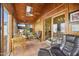 Cozy sunroom showcasing tile flooring, wood paneled walls, and comfortable seating area at 5548 Roan Mountain Pl, Raleigh, NC 27613