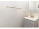 Bathroom featuring a neutral color scheme, a sink with a gold faucet, and a mirror at 5627 Quitman Trl, Raleigh, NC 27610