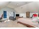 Large bonus room bedroom setup, with a cozy couch and TV at 5627 Quitman Trl, Raleigh, NC 27610