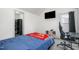 Bedroom with a bed, TV, gaming chair, and a window for natural light at 5627 Quitman Trl, Raleigh, NC 27610
