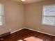 Comfortable bedroom with laminate flooring, natural lighting, and neutral color scheme at 613 Sexton Ave, Zebulon, NC 27597