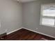 Well-lit bedroom with a window and hardwood floor offering a calming atmosphere at 613 Sexton Ave, Zebulon, NC 27597