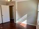 Neutral bedroom with laminate flooring, natural light, and spacious closet at 613 Sexton Ave, Zebulon, NC 27597