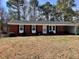 Charming one-story brick home with an attached carport and well-maintained front yard and established trees at 613 Sexton Ave, Zebulon, NC 27597