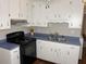 Updated kitchen featuring white cabinets, stainless steel appliances, and modern fixtures at 613 Sexton Ave, Zebulon, NC 27597
