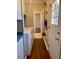 Laundry room features a washer and dryer, storage shelves, and access to the backyard at 613 Sexton Ave, Zebulon, NC 27597