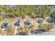 Overhead view of a neighborhood featuring beautiful homes surrounded by lush trees near a tranquil lake at 6935 Old Jefferson Hwy, Cameron, NC 28326