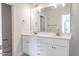 Elegant bathroom with double sinks, white cabinetry, and a large mirror at 6935 Old Jefferson Hwy, Cameron, NC 28326