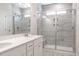 Modern bathroom boasts a double sink vanity, a glass-enclosed shower with gray tiles, and recessed lighting at 6935 Old Jefferson Hwy, Cameron, NC 28326