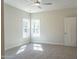 Bright bedroom featuring soft carpeting, a ceiling fan, and two large windows at 6935 Old Jefferson Hwy, Cameron, NC 28326