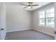 Sunlit bedroom includes plush carpeting and a view to the outdoors through a large window at 6935 Old Jefferson Hwy, Cameron, NC 28326