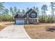 Charming two-story home with gray siding, a well-manicured yard and a two car garage at 6935 Old Jefferson Hwy, Cameron, NC 28326