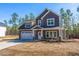 Charming two-story home with gray siding, stone accents, and a well-manicured yard at 6935 Old Jefferson Hwy, Cameron, NC 28326