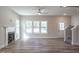 Bright living room features beautiful floors, large windows and modern fireplace at 6935 Old Jefferson Hwy, Cameron, NC 28326