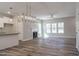 Open-concept living space features a modern fireplace, and flows into the kitchen and dining areas at 6935 Old Jefferson Hwy, Cameron, NC 28326