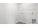 Functional laundry room space with shelving for storage and utility connections at 864 Forth Ct # 150, Gibsonville, NC 27249