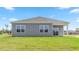 Back exterior view of home with gray siding, and covered patio at 865 Forth Ct # 145, Gibsonville, NC 27249