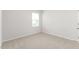 A cozy bedroom with neutral walls, carpet flooring, natural light, and essential electrical outlets at 865 Forth Ct # 145, Gibsonville, NC 27249
