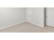 A simple bedroom featuring neutral walls, carpeted floor, white baseboards, and essential electrical outlets at 865 Forth Ct # 145, Gibsonville, NC 27249