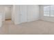 Bright carpeted bedroom featuring a door and a window with blinds at 872 Forth Ct # 149, Gibsonville, NC 27249