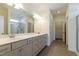 Bright bathroom with double sink vanity, tile flooring, and glass shower with natural light at 88 E Victory View Ter, Smithfield, NC 27577