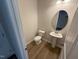 Well lit bathroom features a toilet and vanity with a large mirror at 88 E Victory View Ter, Smithfield, NC 27577