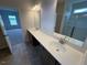 Bathroom showcasing a double sink vanity and a separate tiled shower space at 88 E Victory View Ter, Smithfield, NC 27577