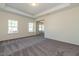 Spacious bedroom with neutral walls, carpet flooring, windows, and access to other rooms at 88 E Victory View Ter, Smithfield, NC 27577