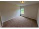 Bright bedroom with neutral carpet, blank walls, and natural light from one window at 88 E Victory View Ter, Smithfield, NC 27577
