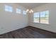 Bright dining room with modern chandelier lighting, lots of natural light, and laminate floors at 88 E Victory View Ter, Smithfield, NC 27577