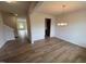 Open dining room featuring wood flooring and a contemporary chandelier at 88 E Victory View Ter, Smithfield, NC 27577