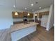 Open-concept kitchen featuring a granite island and wood cabinets at 88 E Victory View Ter, Smithfield, NC 27577