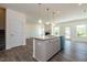 Kitchen featuring an island, pendant lights, laminate flooring, and an open floor plan at 88 E Victory View Ter, Smithfield, NC 27577