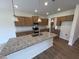 Spacious kitchen with a granite island, stainless appliances and wood cabinets at 88 E Victory View Ter, Smithfield, NC 27577
