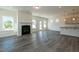 Open living space with a fireplace, leading to the kitchen and with access to the backyard at 88 E Victory View Ter, Smithfield, NC 27577