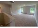 Carpeted living room with natural light from dual windows and neutral paint at 88 E Victory View Ter, Smithfield, NC 27577