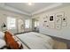 Tranquil main bedroom with a tray ceiling, ample natural light, and a decorative gallery wall at 88 E Victory View Ter, Smithfield, NC 27577