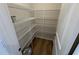 Walk-in pantry with adjustable white wire shelving and wood flooring at 88 E Victory View Ter, Smithfield, NC 27577