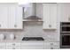 Modern kitchen with white cabinets, stainless steel range hood and herringbone backsplash at 0 Old Middlesex Rd Rd, Middlesex, NC 27557
