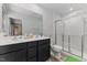 Modern bathroom with double vanity, matte black hardware, shower and tile flooring at 1004 Bridgewater Dr, Durham, NC 27704